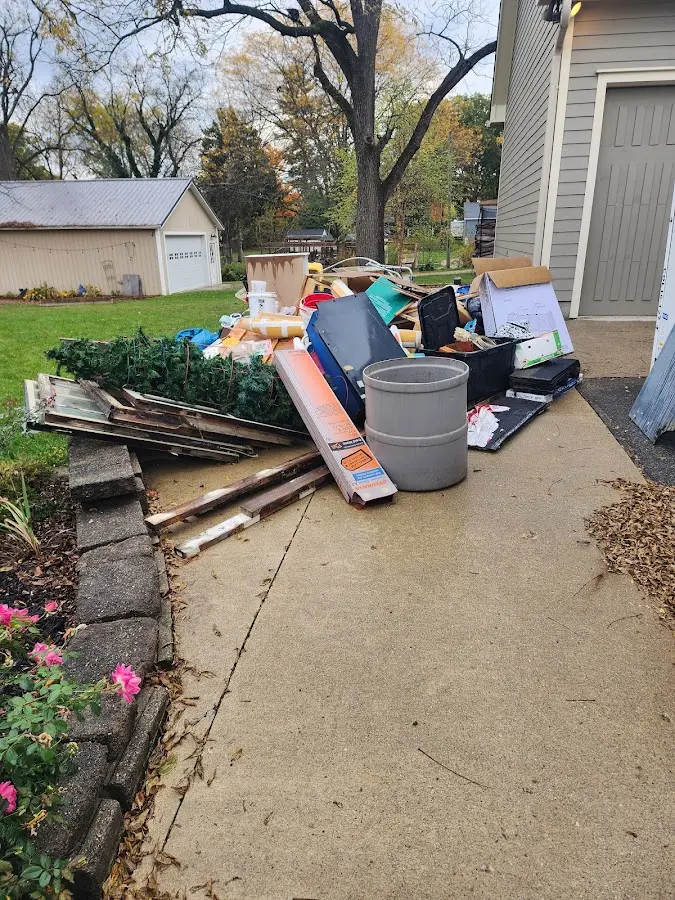 Dumpster being loaded with debris for Commercial Dumpster Rental in Monfort Heights